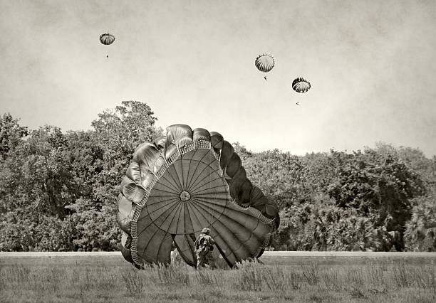 World War 2 era paratroopers World War 2 era soldiers landing on a field world war ii photos stock pictures, royalty-free photos & images