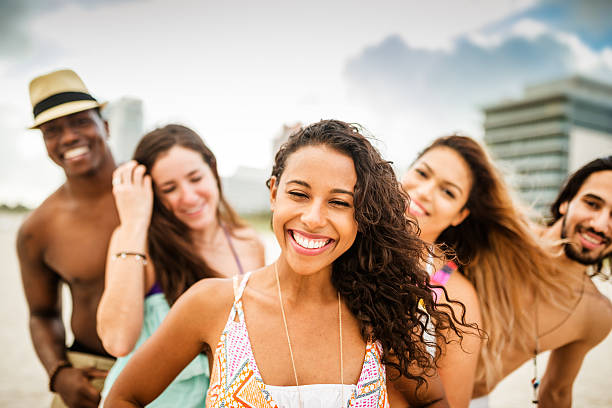 istock friends dancing on the beach for a party 506750048