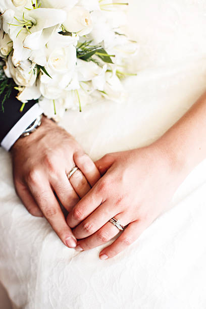 bride and groom hands stock photo