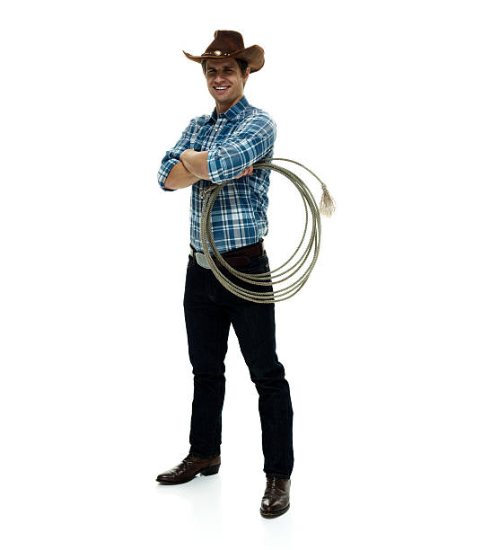 istock Smiling cowboy standing with arms crossed 506752738