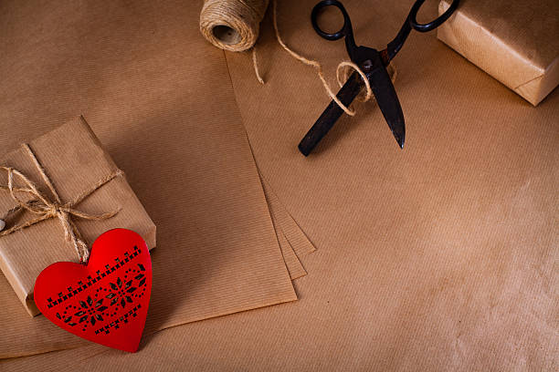 istock Valentines day gift wrapping with boxes and scissors over paper. 506753916