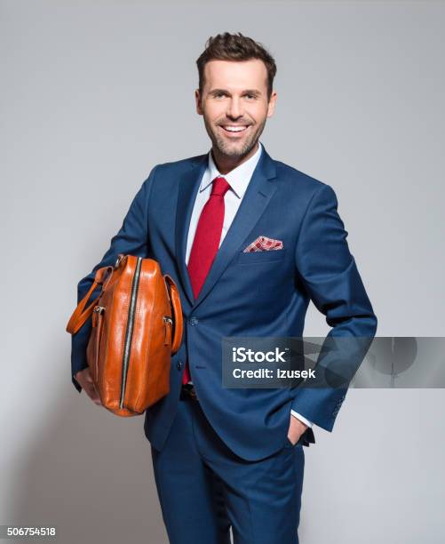 Successful Businessman Wearing Elegant Suit Holding Briefcase Stock Photo - Download Image Now