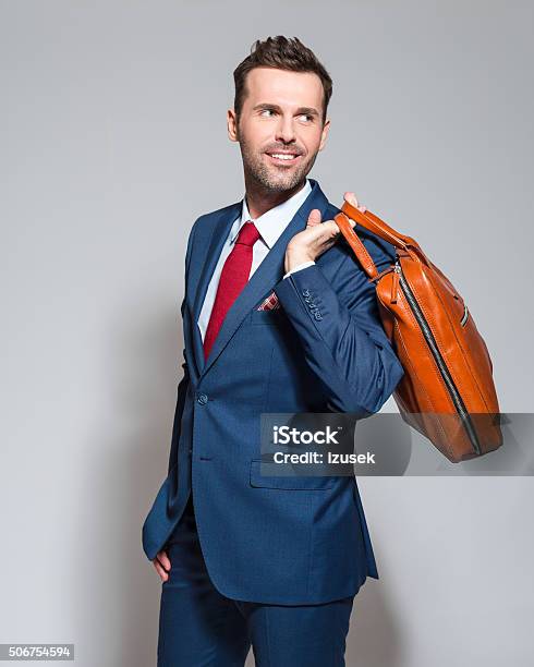 Elegant Businessman Wearing Suit Holding Briefcase Stock Photo - Download Image Now