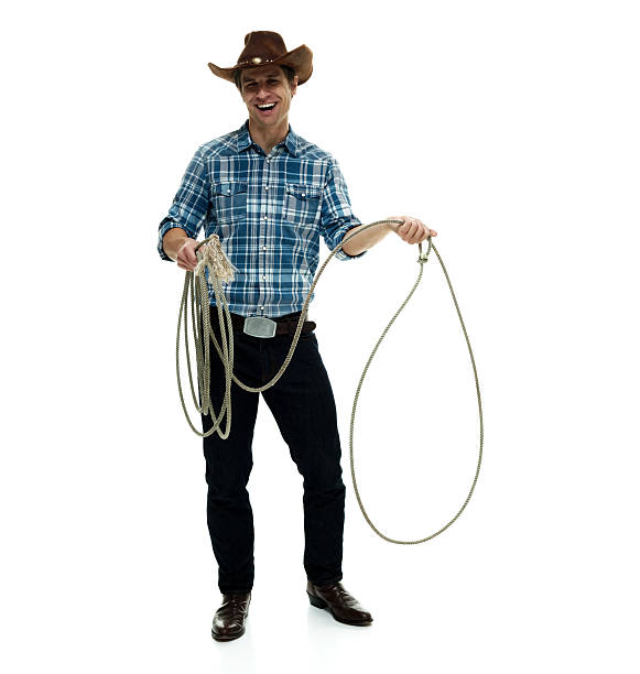 istock Smiling cowboy lassoing 506754628