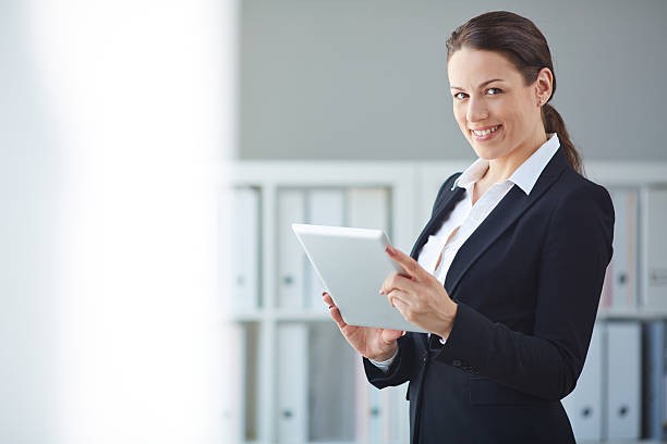 istock Businesswoman with touchpad 506755024