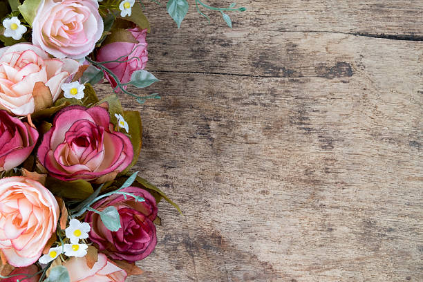 istock Rose flowers on rustic wooden background. Copy space. 506755922