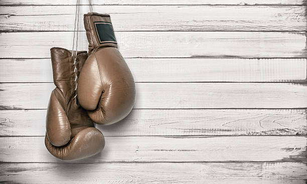 istock Boxing gloves hanging on wooden wall 506756123