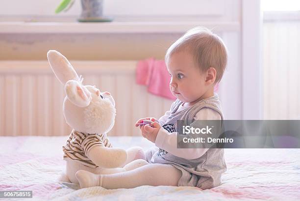 Baby Girl Playing With Plush Rabbit Stock Photo - Download Image Now - Baby - Human Age, Talking, Girls