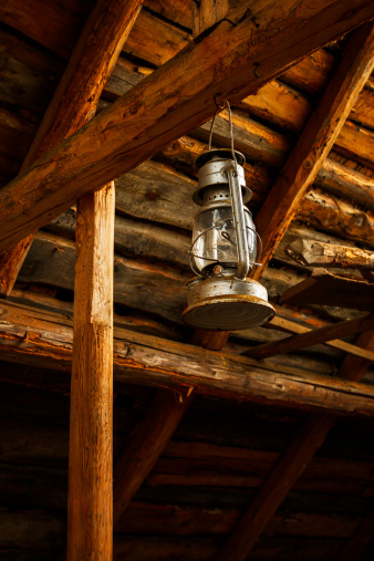 Oil lamp in the slanted ceiling of a barn from early 1900's.