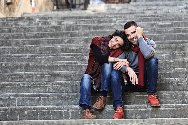 istock Young couple in love sitting on stairs 506759706