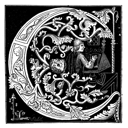 Antique illustration of ornate capital letter C, illustrated with vegetal motifs and a person depicted within the letter space. The person is a man, a monk, reading or working on a manuscript (put on a bookstand) on a table of an ancient monastery library, Engraving by Bouton. The letter is reproduced from a medieval manuscript.