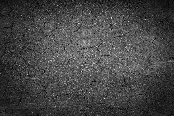 istock crack background texture of rough asphalt 506760497