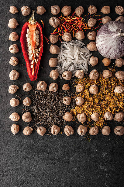 istock Composition of chick-pea  , vegetables and spice on dark stone vertical 506761150