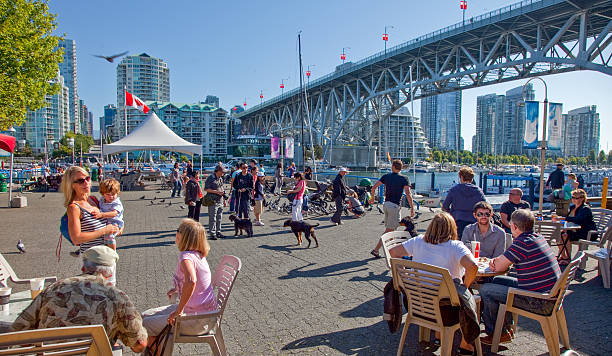 Vancouver, Canada - September 2011 Vancouver, British Columbia, Canada - September 3, 2011: Visitors eating. drinking and enjoying the sunshine on Granville Island in Vancouver. granville island stock pictures, royalty-free photos & images