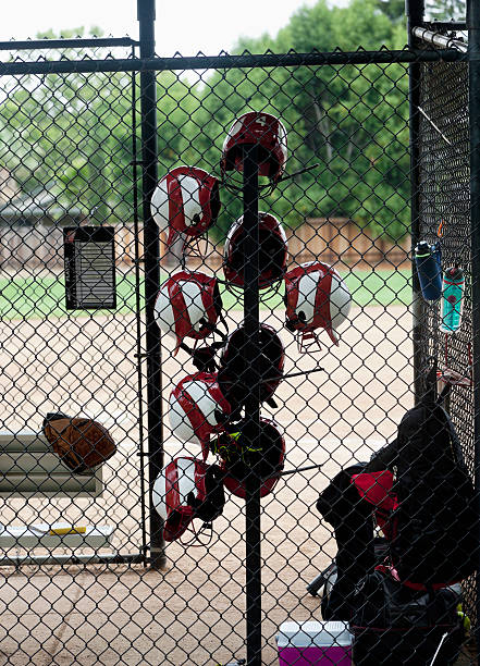 istock softball helmets hanging on rack in dug out 506762535