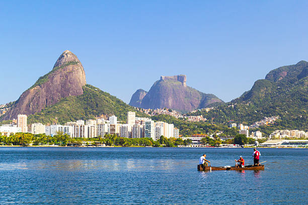 Rio de Janeiro, RJ, Brazil - August 11, 2014: Fishermen at Lagoa Rodrigo de Freitas in Rio de Janeiro. Once contaminated water of the lagoon is now much more cleaner, where fishes are able to grow and reproduce, sustaining a way of work for many low weath people.