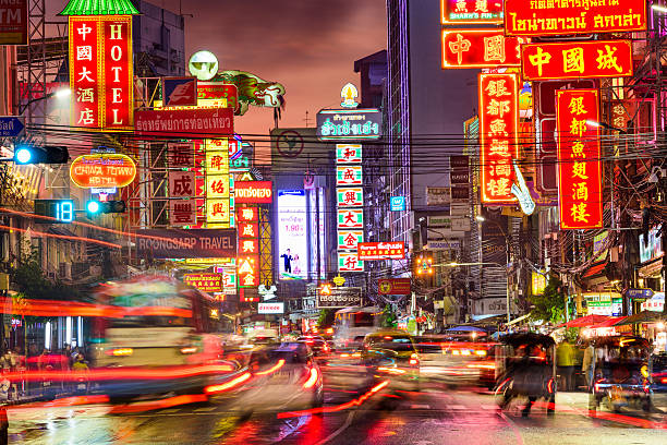 Bangkok Thailand Chinatown Bangkok, Thailand - September 27, 2015: Heavy traffic on Yaowarat Road passes below lit signs in the Chinatown district at dusk. Yaowarat has been the main center of Chinese culture in Bangkok for over 200 years. bangkok street stock pictures, royalty-free photos & images