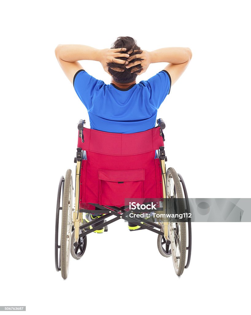 handicapped man sitting on a wheelchair and painful pose handicapped man sitting on a wheelchair and painful pose isolated on white background Displeased Stock Photo