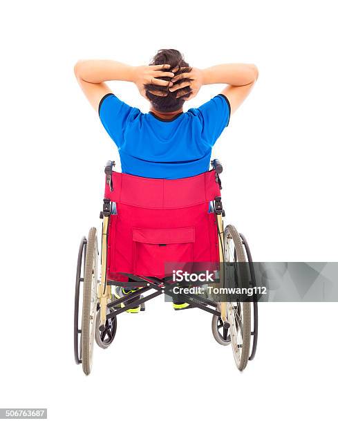 Handicapped Man Sitting On A Wheelchair And Painful Pose Stock Photo - Download Image Now