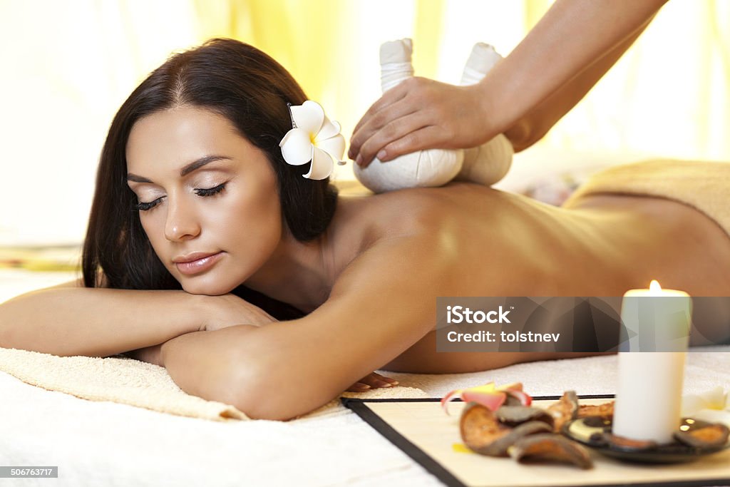 Young woman getting massage in Thai spa. portrait of young beautiful woman in spa environment Achievement Stock Photo