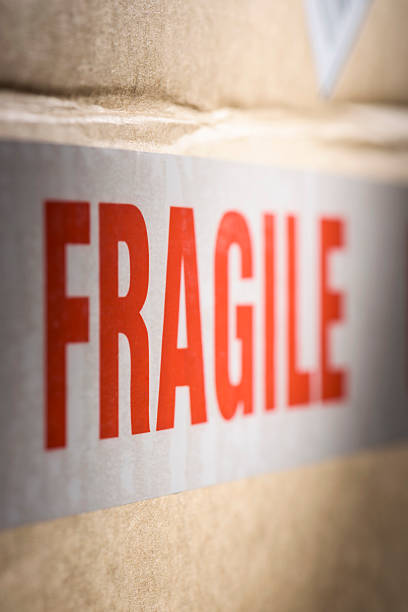 istock Fragile tape wrapped around a brown cardboard delivery box 506766698