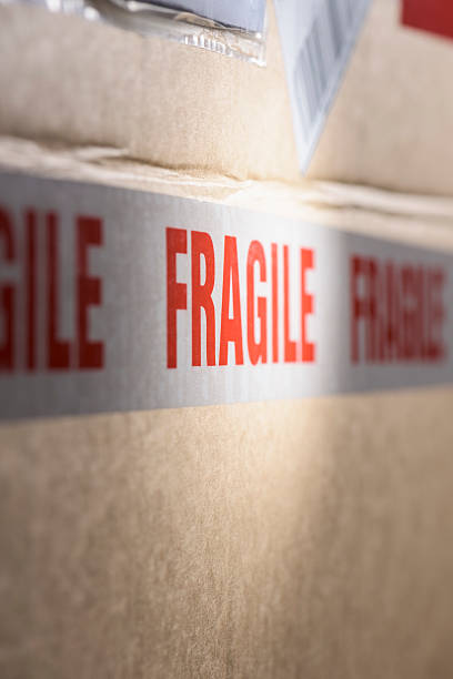 istock Fragile tape wrapped around a brown cardboard delivery box 506766762
