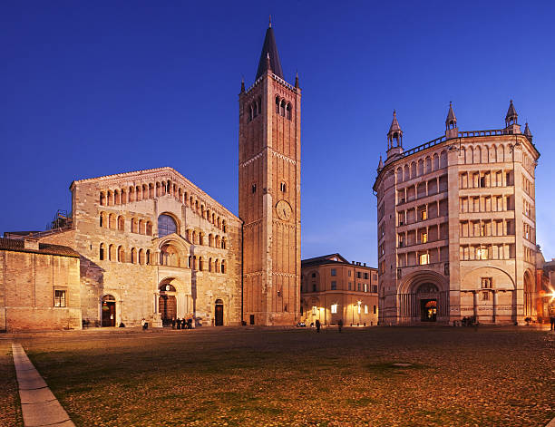 Parma cathedral - Italy Parma Cathedral (Duomo) and the beautiful Baptistery (Battistero) in Emilia Romagna, Italy, illuminated at dusk. parma italy stock pictures, royalty-free photos & images