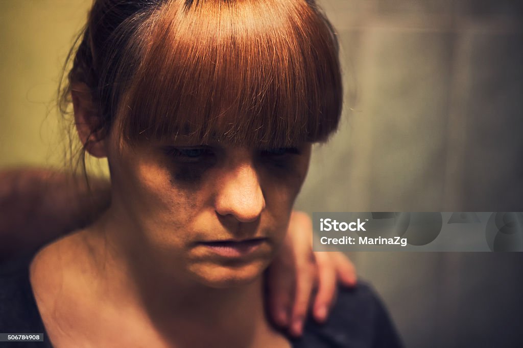 Comforting hand on a shoulder of crying abused woman Abuse Stock Photo