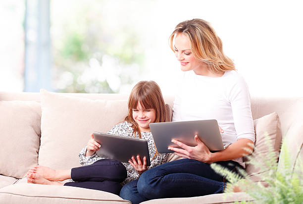 istock Mother and daughter at living room 506785196