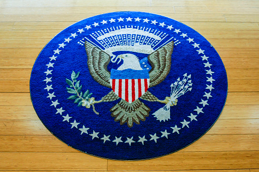 Little Rock, AR, USA - June 12, 2015: Hand Woven carpet of the insignia of the United States of America set into the wood floor at the William J. Clinton Presidential Center in Little Rock Arkansas