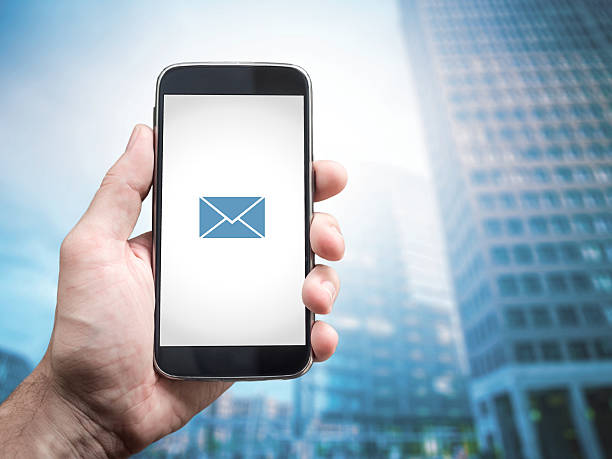 istock Hand holding mobile smart phone with message on a screen 506789534