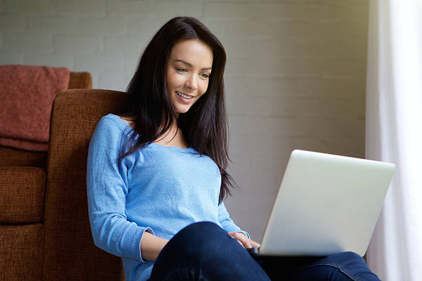 istock Young woman sitting at home using laptop 506790488