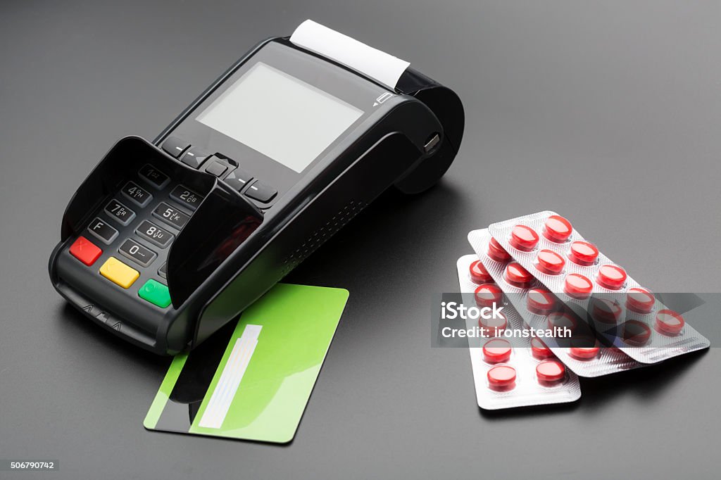 POS terminal, credit card and pill blister pack POS terminal, debit card and pill blister pack over black ATM Stock Photo