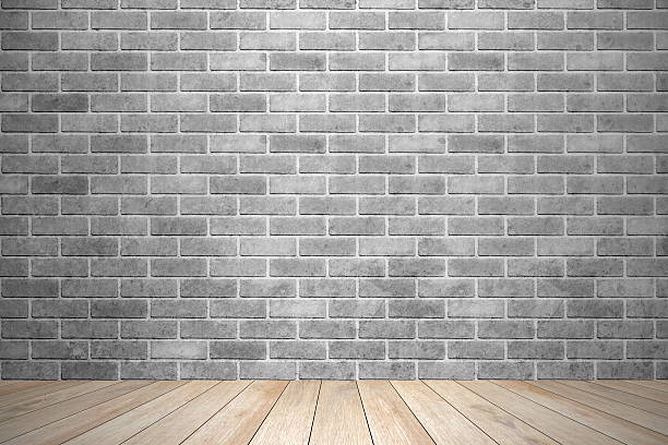 interior room with black brick wall and wooden floor stock photo
