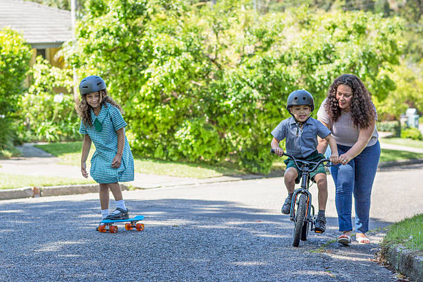 istock Mum teaching her son to ride a bike 506791314