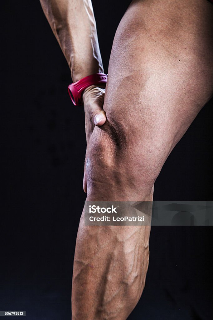 Knee pain Knee pain on a muscular body builder. Adult Stock Photo
