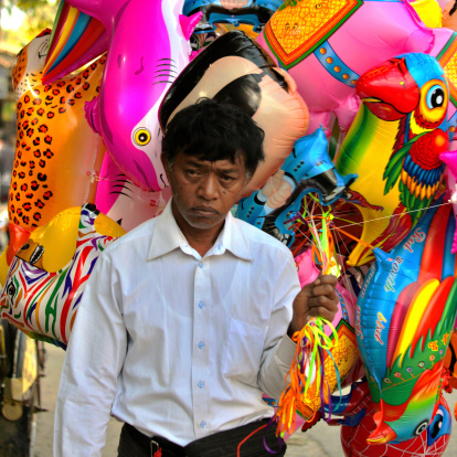 Bagan, Burma/Myanmar - January 16, 2014: Burmese man selling baloons on a marketplace in Bagan, Burma /Myanmar