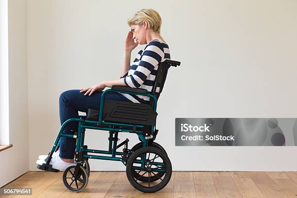 Woman Sitting In Wheelchair Stock Photo - Download Image Now - Sadness, One Woman Only, Persons with Disabilities