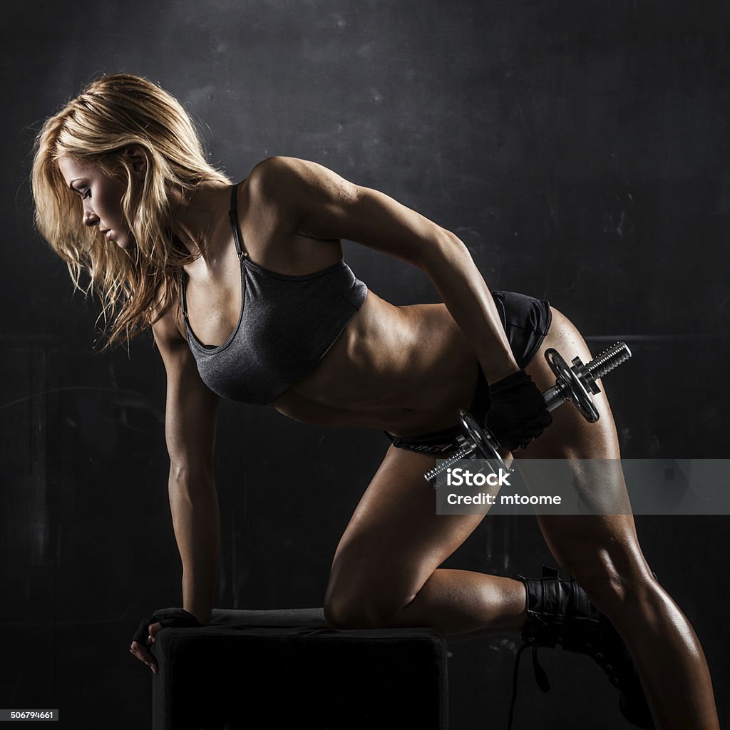 Fitness with dumbbells Brutal athletic woman pumping up muscles with dumbbells Abdominal Muscle Stock Photo