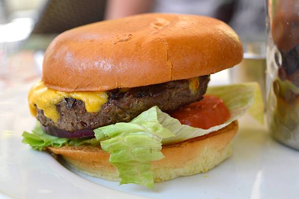 istock Burger with cheese, lettuce and tomato. 506794853