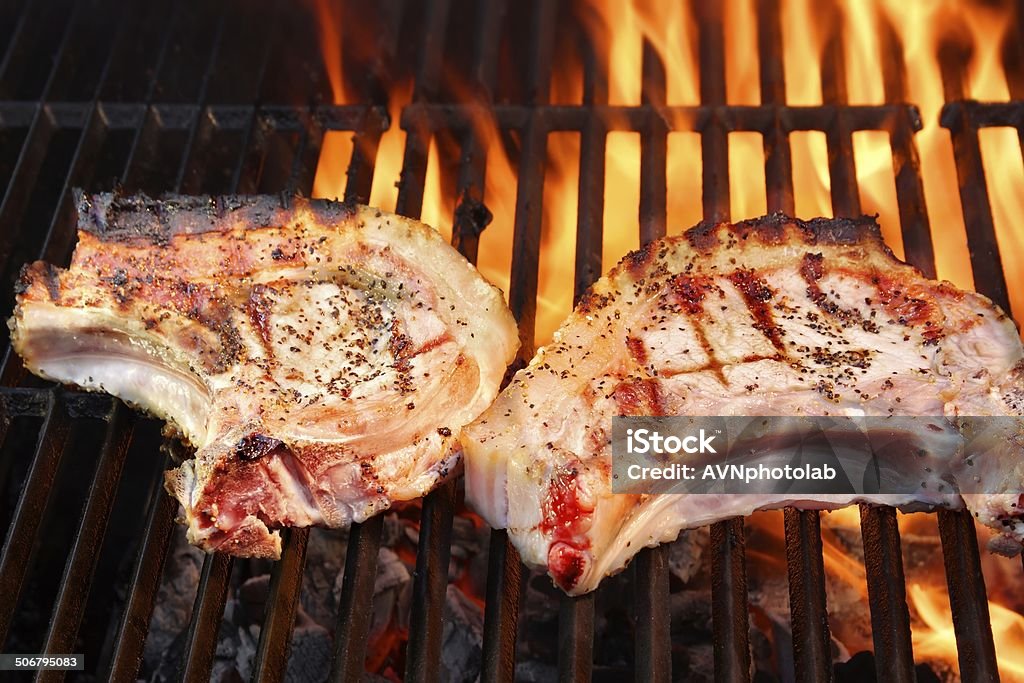 Pork Loin Steaks Pork Loin Steak on a Flaming BBQ grill American Culture Stock Photo