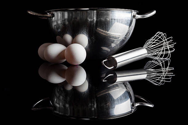 istock Steel bowl whisker eggs side view with reflection on black 506796200