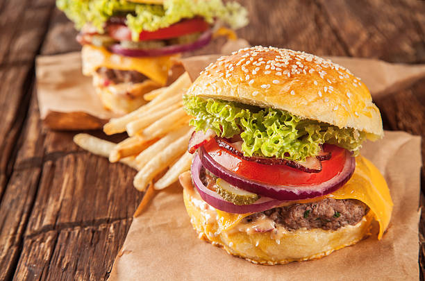 istock Fresh hamburger with fries served on wood 506796675