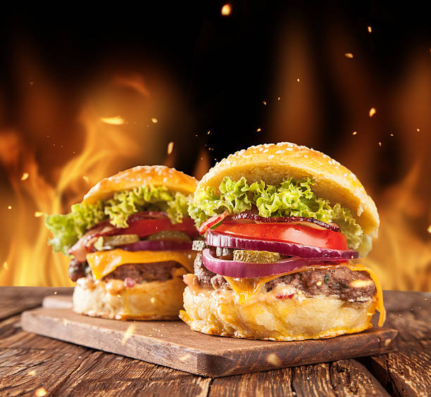 istock Fresh hamburgers with fire flames 506796707