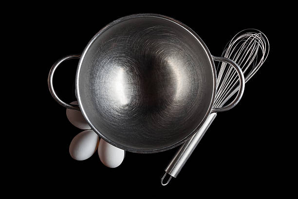 istock Steel bowl whisker eggs from above on black 506796958