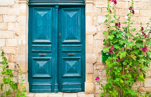 istock blue front door with purple flowers 506797387