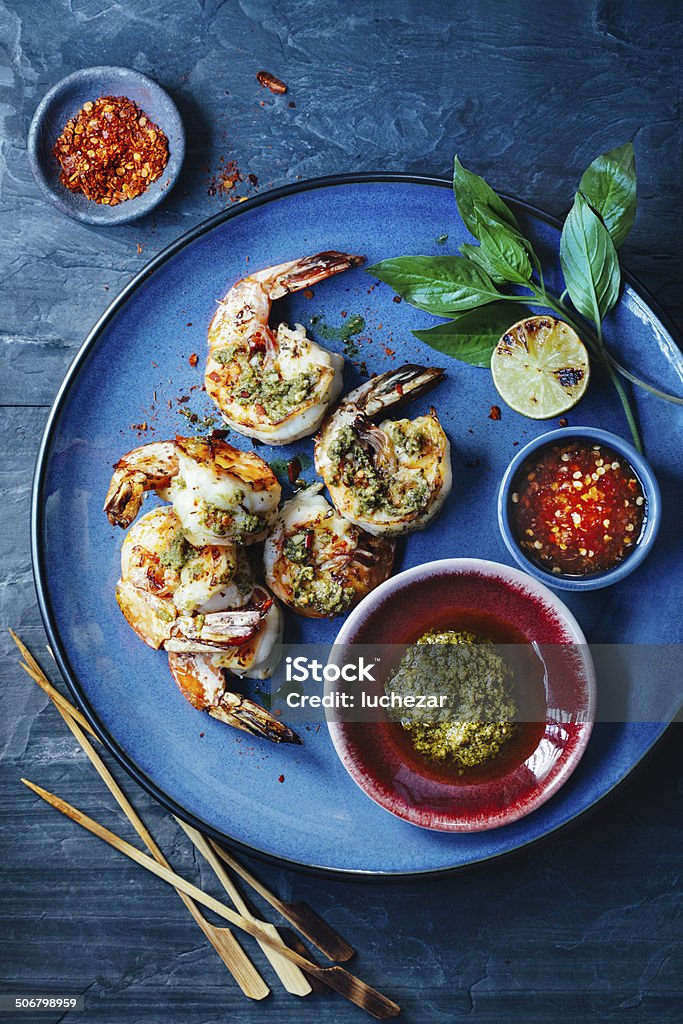 Shrimp satay Shrimp satay with pesto and chili sauces Blue Stock Photo