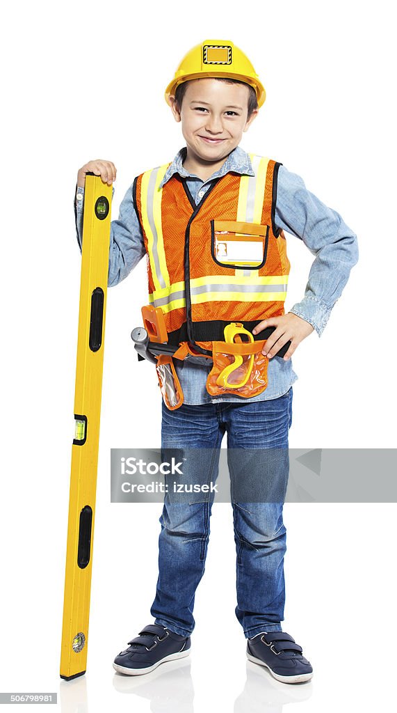 Junior Construction Worker Portrait of little boy dressed as contruction worker, holding a level in hand and smiling at camera. Studio shot, isolated on white. Child Stock Photo