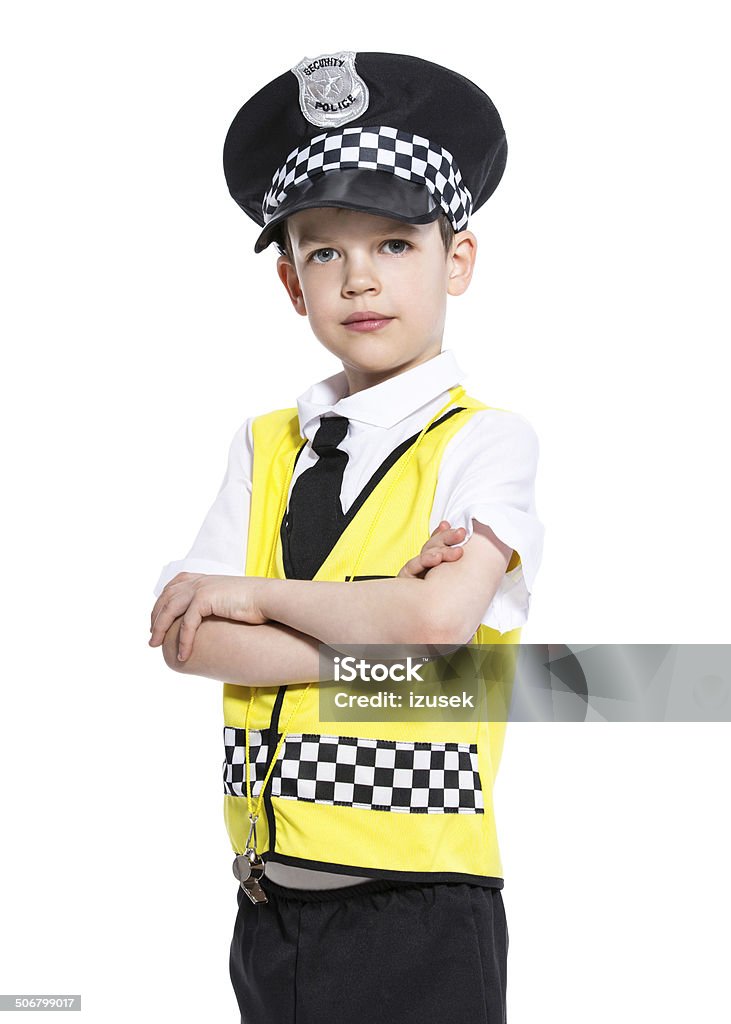Junior Policeman Portrait of little boy dressed as a policeman, standing with arms crossed and looking at camera. Studio shot, isolated on white. Child Stock Photo
