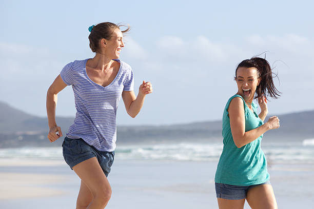 istock Two friends running in summer at the beach 506801370